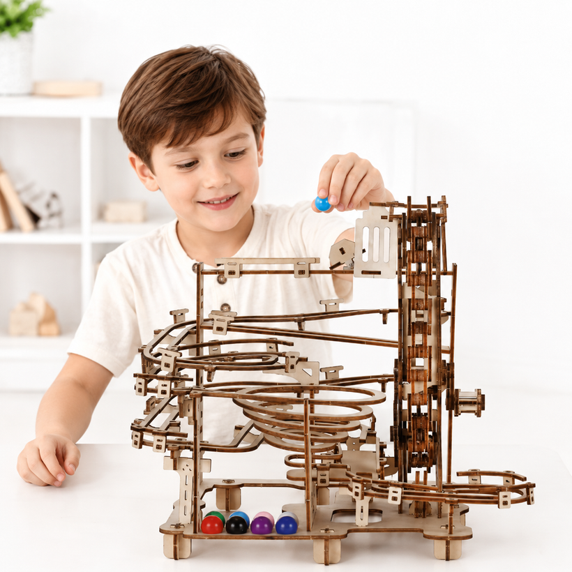 Child playing with a wooden marble run